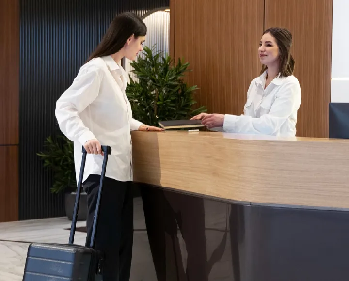 Hotel reception team welcoming a guest